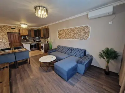 a living room with a blue couch and a table at MitProt Panorama Bay 2 Luks Apartment 110 in Sveti Vlas