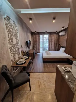 a large room with a bed and a table and chairs at Mit Prot Panorama Bay 2 luks Studio 40 in Sveti Vlas
