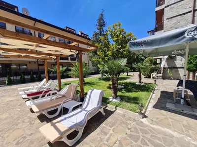 a group of lounge chairs and umbrellas on a patio at Mit Prot Panorama Bay 2 luks Studio 40 in Sveti Vlas