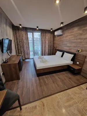 a large bedroom with a bed and a television at Mit Prot Panorama Bay 2 luks Studio 40 in Sveti Vlas