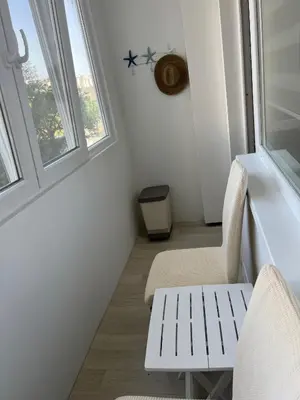 a room with two chairs and a window at Tei-Zi apartments2 in Burgas City