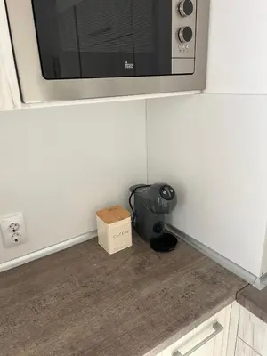 a box sitting on the floor under a microwave at Tei-Zi apartments2 in Burgas City
