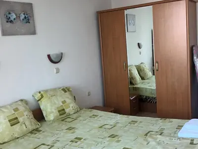 a bedroom with a bed and a mirror at Cozy apartment in Kambani 1 in Sveti Vlas