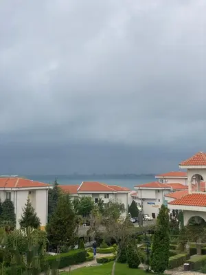 a group of buildings with the ocean in the background at Cozy apartment in Kambani 1 in Sveti Vlas