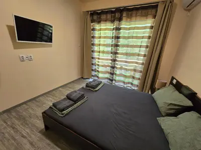 a bedroom with a bed with two towels on it at Ах, морето !!! in Tsarevo