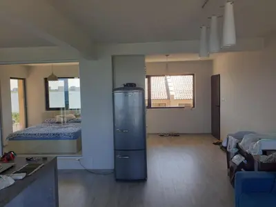 a room with a room with a bed and a refrigerator at Solar Rise apartment in Pomorie