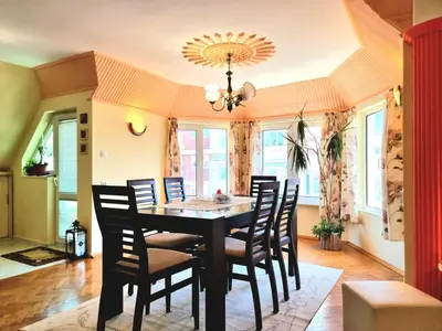 a dining room with a table and chairs at Two-Floor Sunny Apartment in City Centre in Burgas City