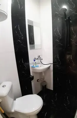 a bathroom with a white toilet and a sink at STUDIO MORARo in Varna City