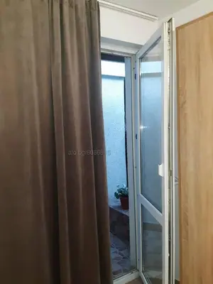 a sliding glass door leading to a room with a window at STUDIO MORARo in Varna City