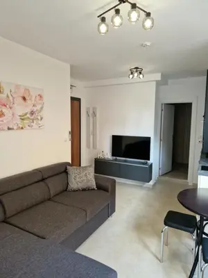 a living room with a couch and a flat screen tv at Polarstar 205A am Meer Sveti Vlas in Sveti Vlas
