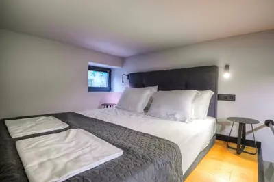 a bedroom with a large bed with white pillows at Smart Rooms in Varna City