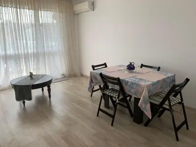 a dining room with a table and two chairs at Sunny holidays in Byala
