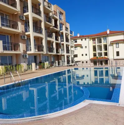 a swimming pool in front of a apartment building at Sunny holidays in Byala