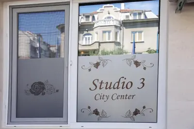 a window with a sign that reads studio city center at Deluxe 3 Studio City Center in Burgas City