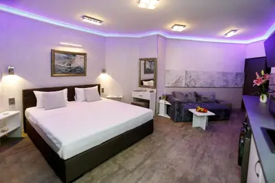 a hotel room with a bed and a couch at Deluxe 3 Studio City Center in Burgas City