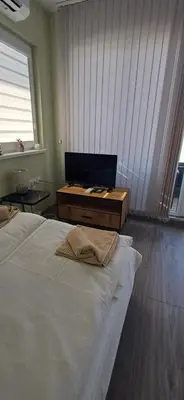a bedroom with a large bed and a wooden table at Paradise villas in Sozopol