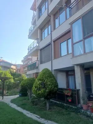 an apartment building with a bush in front of it at Апартамент РАЯ in Sozopol