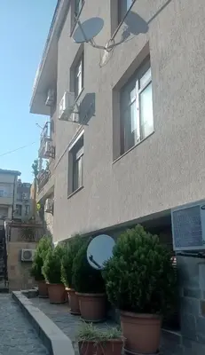 a building with potted plants in front of it at Апартамент РАЯ in Sozopol