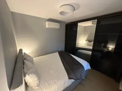 a small bedroom with a bed and a mirror at Cosy Apartment - Top Location in Burgas City