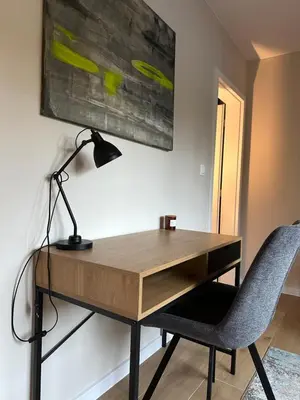 a desk with a lamp and a chair in a room at Cosy Apartment - Top Location in Burgas City