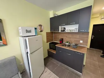 a kitchen with a white refrigerator and a sink at VP Martini in Sunny Beach