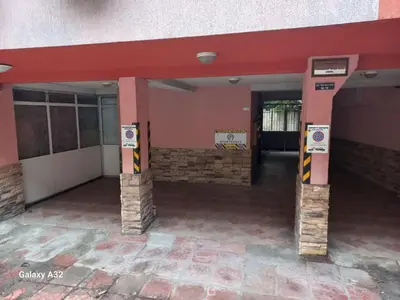 a building with two pillars with a parking sign in front at SPS Apartment in Varna City