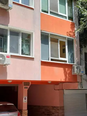 a building with windows and a car parked in front at SPS Apartment in Varna City