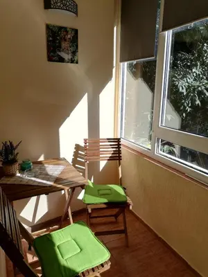 a room with a table and chairs and a window at SPS Apartment in Varna City