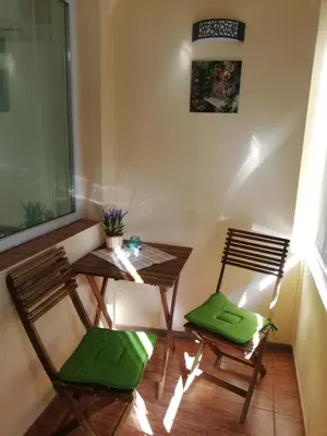 a small table and two chairs in a room at SPS Apartment in Varna City