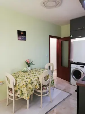 a dining room table and chairs in a kitchen at SPS Apartment in Varna City