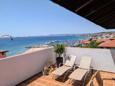 a balcony with chairs and a view of the beach at Beachfront Apartment Sveti Vlas in Sveti Vlas