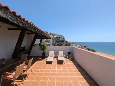 a balcony with chairs and a view of the ocean at Beachfront Apartment Sveti Vlas in Sveti Vlas