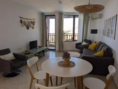 a living room with a table and a couch at Beachfront Apartment Sveti Vlas in Sveti Vlas
