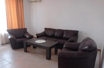 a living room with two couches and a coffee table at Апартамент Плаж Червенка in Chernomorets