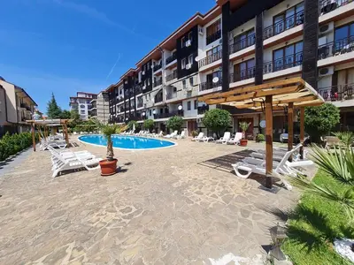 a resort with a pool and chairs and a hotel at MitProt Panorama Bay2 Luks Apartment 174 in Sveti Vlas