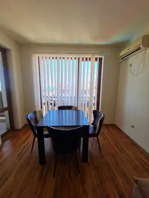 a dining room with a blue table and chairs at MitProt Panorama Bay2 Luks Apartment 174 in Sveti Vlas