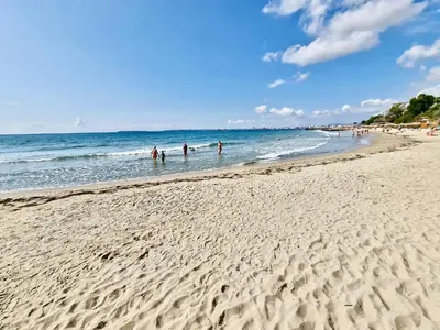 a group of people in the water at the beach at Апартамент СВЕТИ ВЛАС 1 in Sveti Vlas