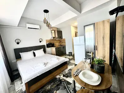 a small bedroom with a bed and a table at Студио СВЕТИ ВЛАС 2 in Sveti Vlas
