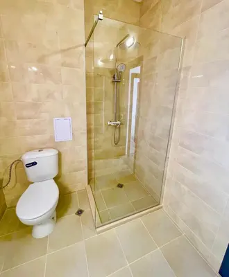 a bathroom with a shower and a toilet at Majestic Villas Pomorie Park in Sarafovo