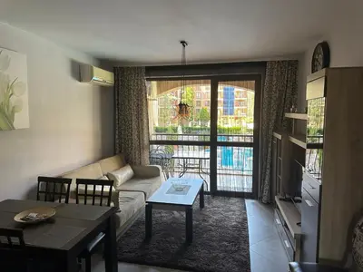 a living room with a couch and a table at Kalia A5 Sunny Beach in Sunny Beach