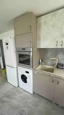 a kitchen with a washing machine and a refrigerator at Studio Kikki Sozopol in Sozopol