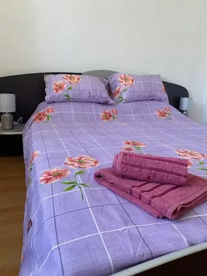 a purple bed with pink blankets and pillows on it at 2 Bedroom Apartment at Kasandra in Sunny Beach