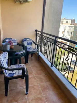 a balcony with two chairs and a table and a balcony at 2 Bedroom Apartment at Kasandra in Sunny Beach