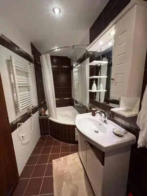 a bathroom with a tub and a sink and a bath tub at Roman Thermae Heritage Penthouse with Garage in Varna City