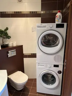 a washer and dryer in a bathroom with a toilet at Roman Thermae Heritage Penthouse with Garage in Varna City
