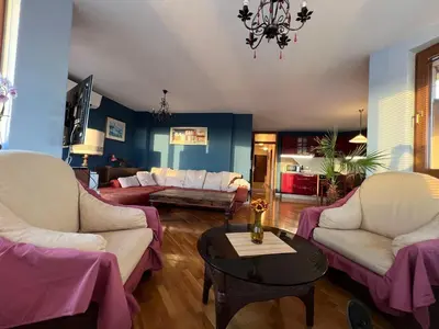 a living room with two couches and a table at Roman Thermae Heritage Penthouse with Garage in Varna City