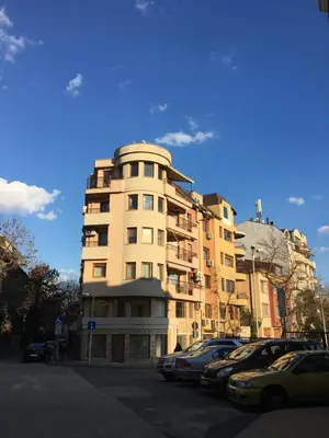a tall building with cars parked in front of it at Roman Thermae Heritage Penthouse with Garage in Varna City