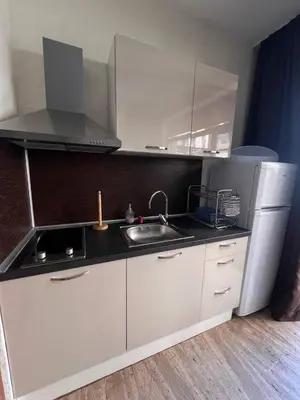 a small kitchen with a sink and a refrigerator at Комплекс Амара А4 in Sunny Beach