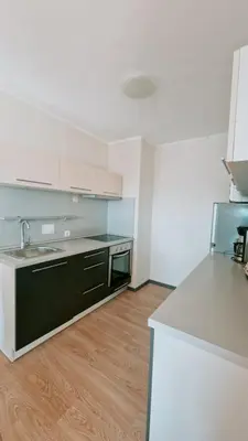 an empty kitchen with a sink and a counter at Апартаменти Бяла Бийч - Apartments Byala Beach in Byala