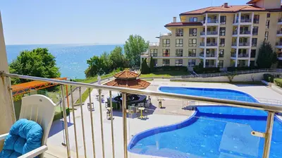 a balcony with a view of a hotel and a swimming pool at Апартаменти Бяла Бийч - Apartments Byala Beach in Byala